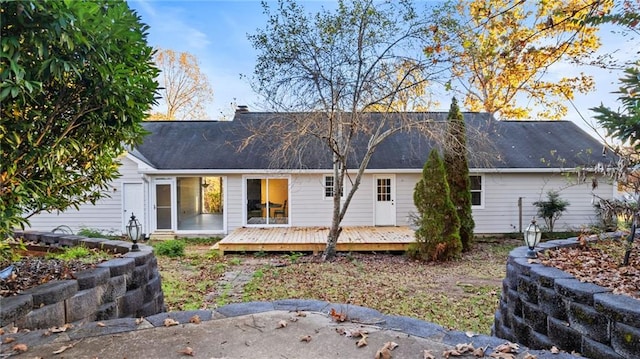 rear view of property with a wooden deck