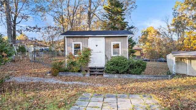 view of shed featuring fence