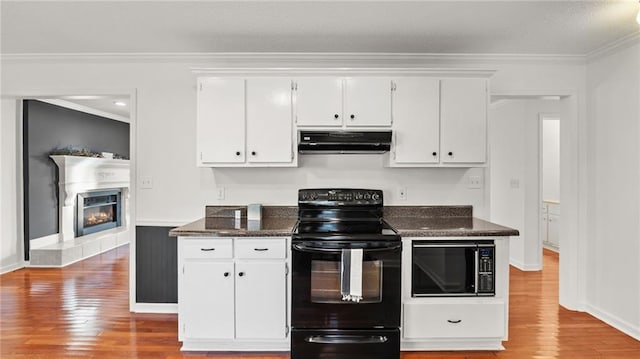 kitchen featuring black appliances, ornamental molding, white cabinetry, and under cabinet range hood