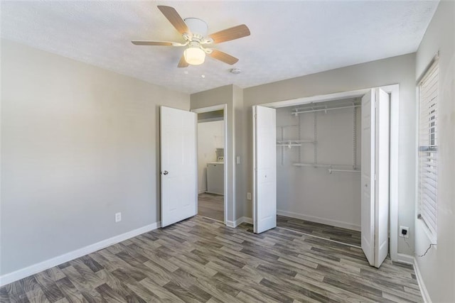 unfurnished bedroom with dark hardwood / wood-style flooring, a closet, and ceiling fan