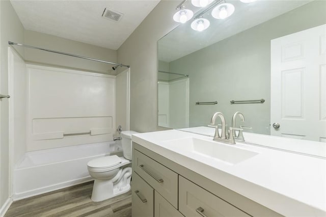 full bathroom featuring vanity, shower / bathing tub combination, hardwood / wood-style floors, and toilet