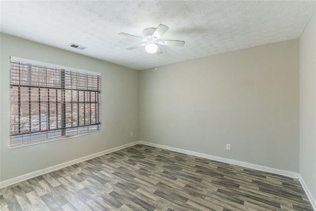 empty room with ceiling fan, hardwood / wood-style flooring, and a textured ceiling