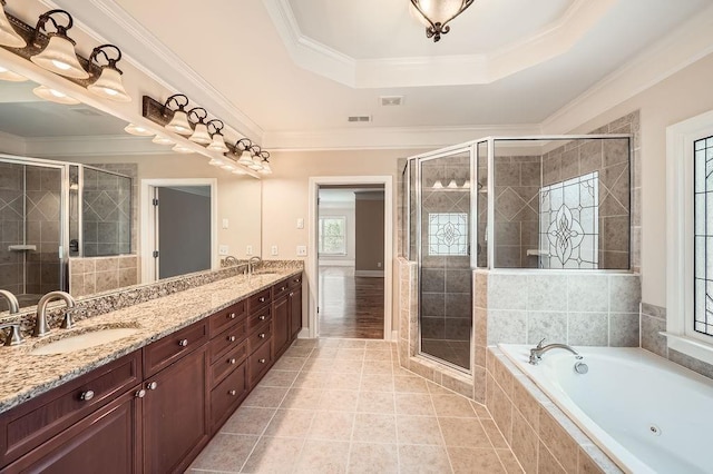 bathroom with visible vents, double vanity, a bath, a sink, and a stall shower