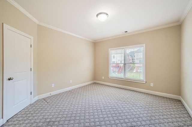 carpeted empty room with baseboards, visible vents, and ornamental molding