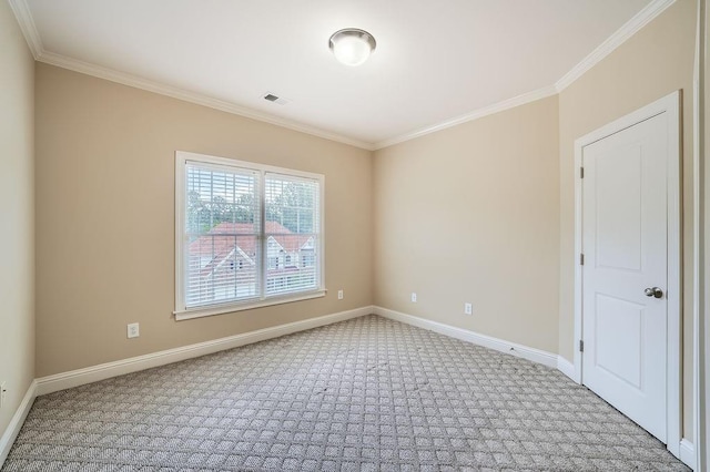 carpeted empty room with baseboards, visible vents, and ornamental molding