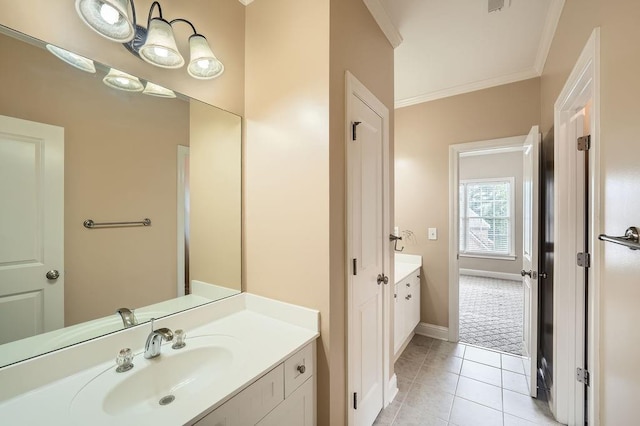 bathroom with vanity, tile patterned floors, baseboards, visible vents, and ornamental molding