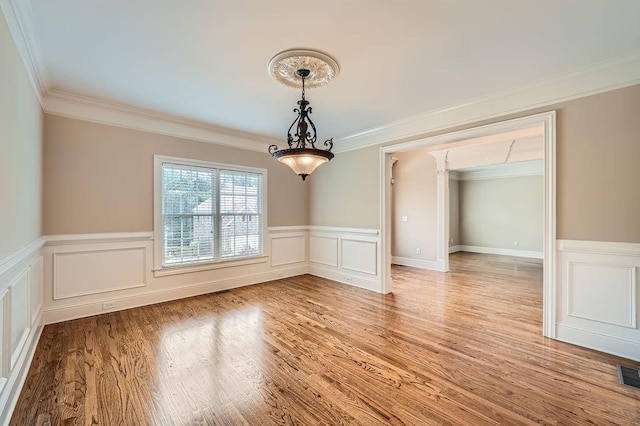 interior space with wainscoting and ornamental molding