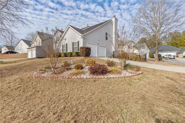 view of home's exterior with a garage and a lawn