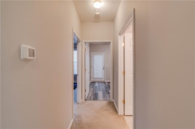 124 Camry Ln, Grayson, GA 30017 - hall with light colored carpet, a textured ceiling, and baseboards