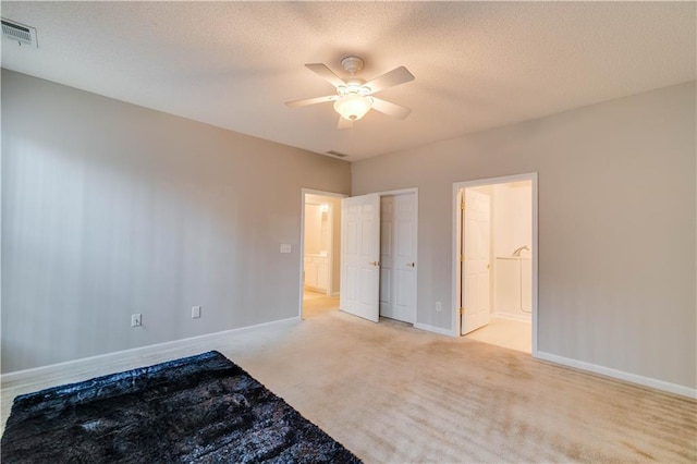 124 Camry Ln, Grayson, GA 30017 - unfurnished bedroom with baseboards, light colored carpet, connected bathroom, a ceiling fan, and a textured ceiling