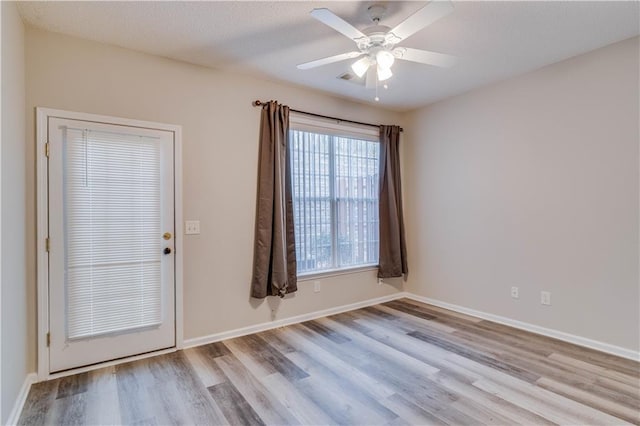124 Camry Ln, Grayson, GA 30017 - spare room with wood finished floors, a ceiling fan, and baseboards