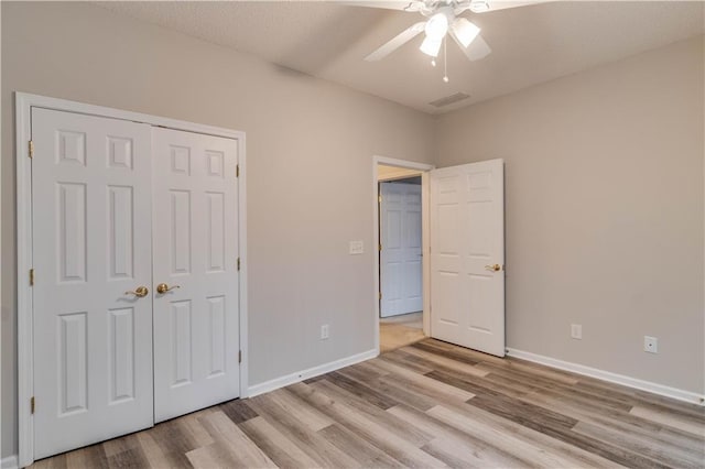 124 Camry Ln, Grayson, GA 30017 - unfurnished bedroom featuring light wood finished floors, baseboards, a ceiling fan, and a closet