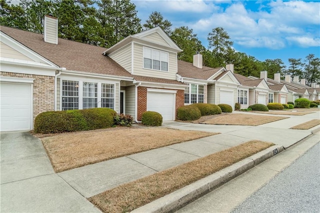 124 Camry Ln, Grayson, GA 30017 - view of front of house featuring a chimney, driveway, a garage, and brick siding