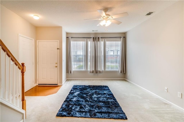 124 Camry Ln, Grayson, GA 30017 - entryway with carpet flooring, a ceiling fan, stairway, baseboards, and a textured ceiling