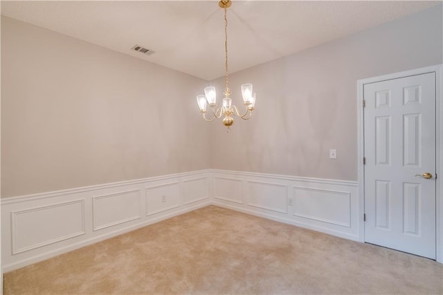 124 Camry Ln, Grayson, GA 30017 - unfurnished room featuring a chandelier, light colored carpet, a wainscoted wall, and a decorative wall