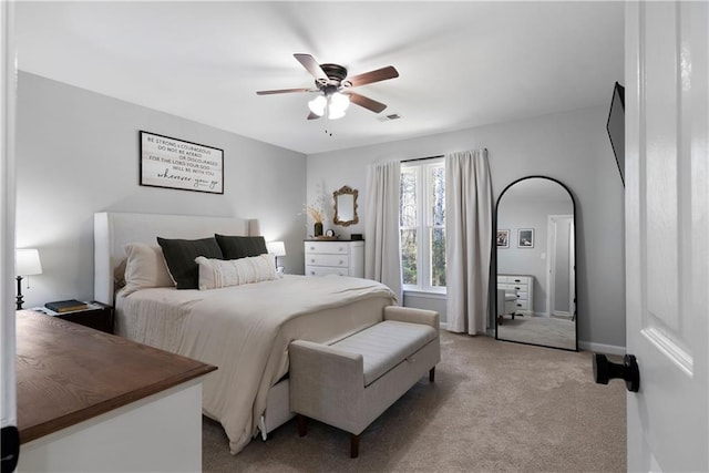 bedroom featuring visible vents, light carpet, baseboards, and a ceiling fan