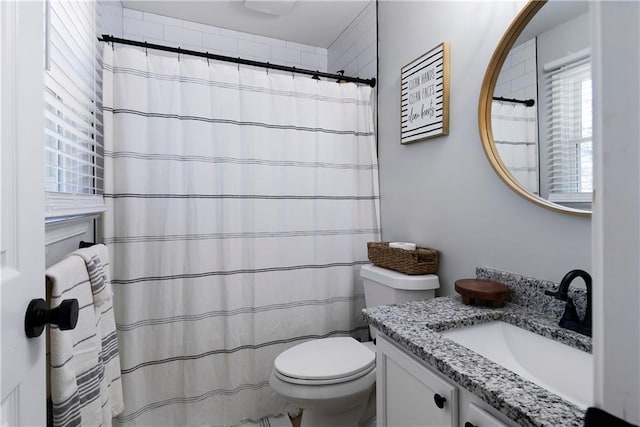 bathroom featuring vanity, toilet, and a shower with curtain