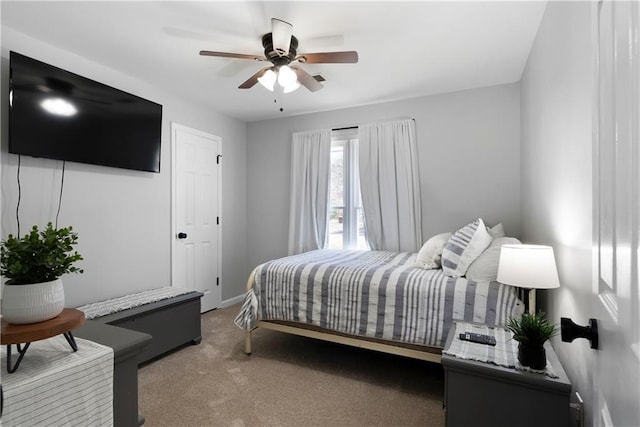 bedroom featuring light carpet, baseboards, and ceiling fan