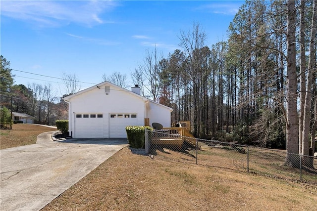 view of property exterior featuring fence, a garage, and a chimney