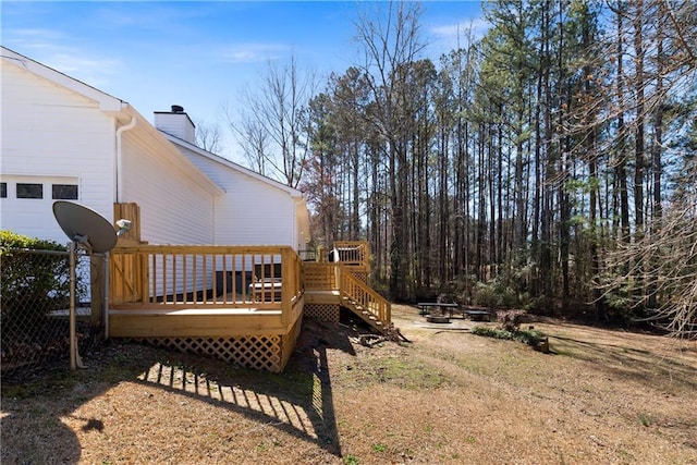 view of yard with a wooden deck and a fire pit