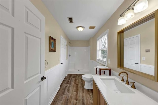 1141 Planing Mill Rd, Greensboro, GA 30642 - bathroom with a shower, toilet, wood finished floors, and vanity