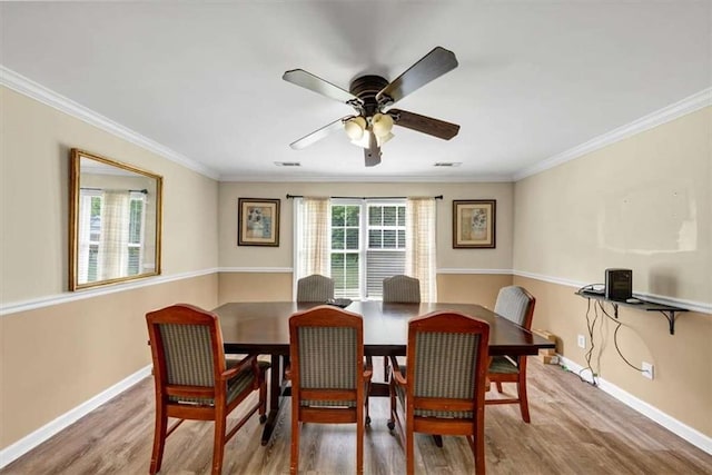 1141 Planing Mill Rd, Greensboro, GA 30642 - dining area with baseboards, wood finished floors, ceiling fan, and crown molding