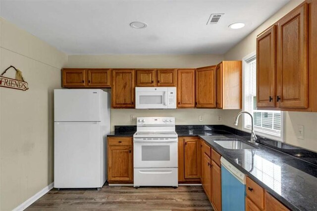 1141 Planing Mill Rd, Greensboro, GA 30642 - kitchen featuring white appliances, a sink, brown cabinets, and dark wood-style flooring