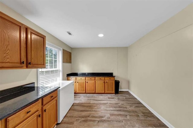1141 Planing Mill Rd, Greensboro, GA 30642 - kitchen with light wood-style flooring, recessed lighting, and brown cabinets