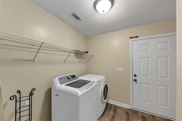 1141 Planing Mill Rd, Greensboro, GA 30642 - washroom with independent washer and dryer, dark wood finished floors, and baseboards