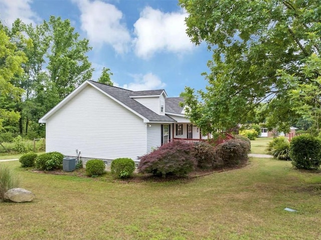 1141 Planing Mill Rd, Greensboro, GA 30642 - view of side of home with a yard, cooling unit, covered porch, and roof with shingles