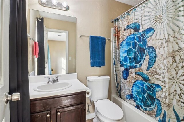 full bathroom featuring shower / bathtub combination with curtain, vanity, and toilet