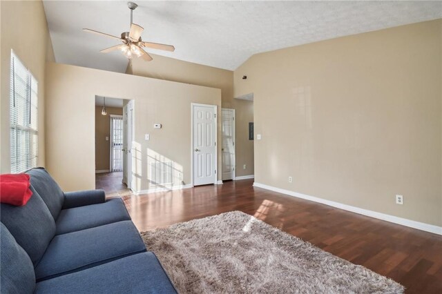 living room with dark hardwood / wood-style flooring, vaulted ceiling, and ceiling fan