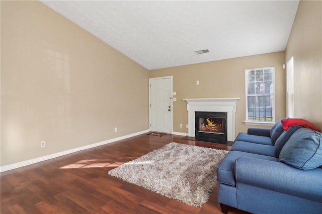 living room with dark hardwood / wood-style flooring and vaulted ceiling