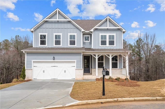 craftsman-style home featuring a garage, covered porch, board and batten siding, and brick siding