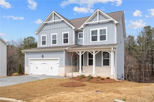 view of front of home with brick siding, board and batten siding, a porch, concrete driveway, and an attached garage