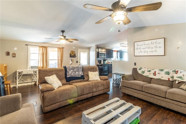 living area featuring a ceiling fan, vaulted ceiling, and wood finished floors