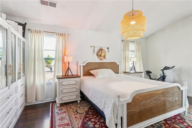 bedroom with dark wood-type flooring