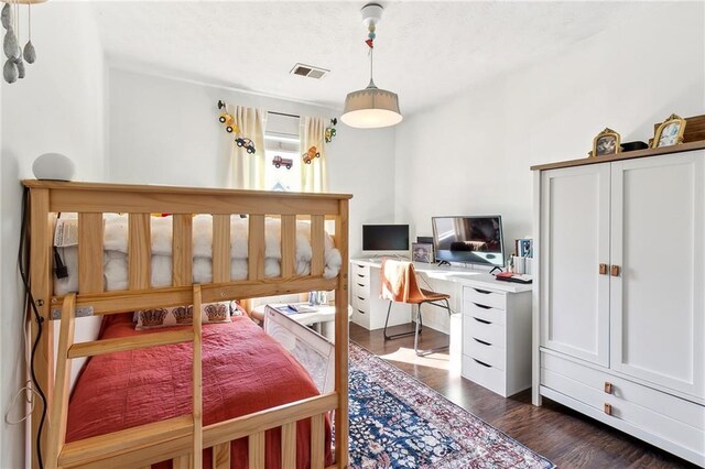 bedroom featuring dark hardwood / wood-style floors