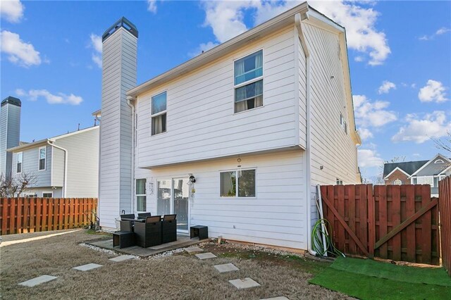 back of property with a patio