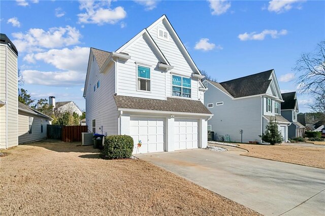 view of front of house with a garage and central AC