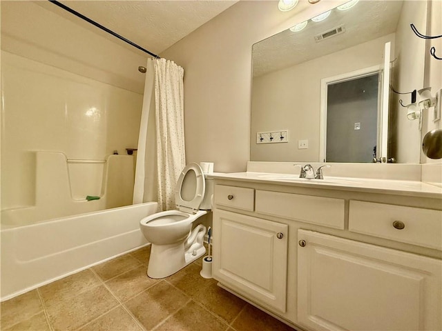 full bathroom with shower / tub combo with curtain, vanity, toilet, and a textured ceiling