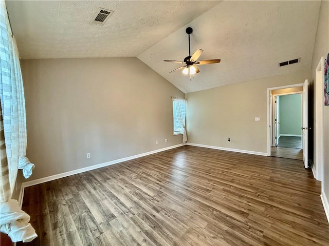 unfurnished bedroom with vaulted ceiling, ceiling fan, hardwood / wood-style floors, and a textured ceiling