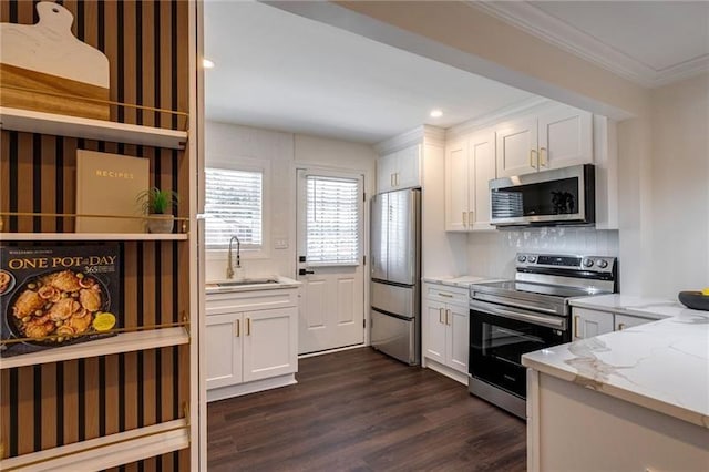 4282 Roswell Rd NE Unit G1, Atlanta, GA 30342 - kitchen with stainless steel appliances, a sink, dark wood finished floors, crown molding, and light stone counters