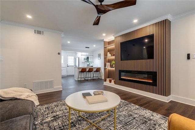 4282 Roswell Rd NE Unit G1, Atlanta, GA 30342 - living area with crown molding, wood finished floors, baseboards, a glass covered fireplace, and recessed lighting