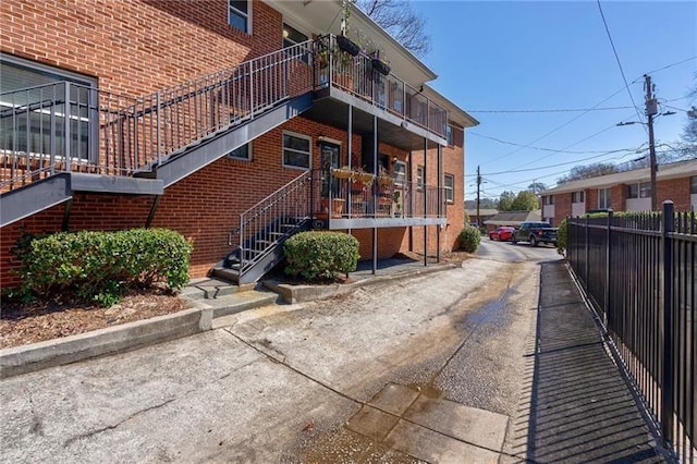 4282 Roswell Rd NE Unit G1, Atlanta, GA 30342 - view of side of property with brick siding, stairway, and a balcony