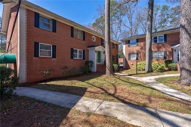 4282 Roswell Rd NE Unit G1, Atlanta, GA 30342 - view of property with brick siding and a front lawn