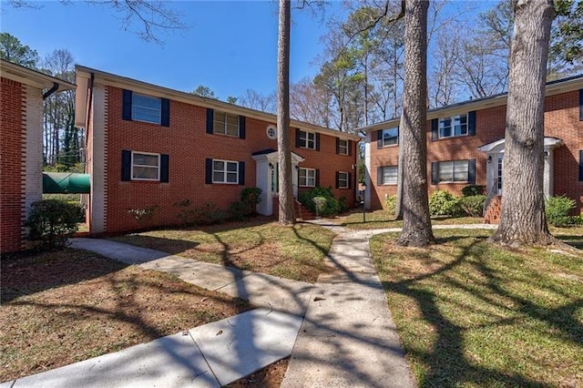 4282 Roswell Rd NE Unit G1, Atlanta, GA 30342 - view of front facade featuring brick siding and a front lawn