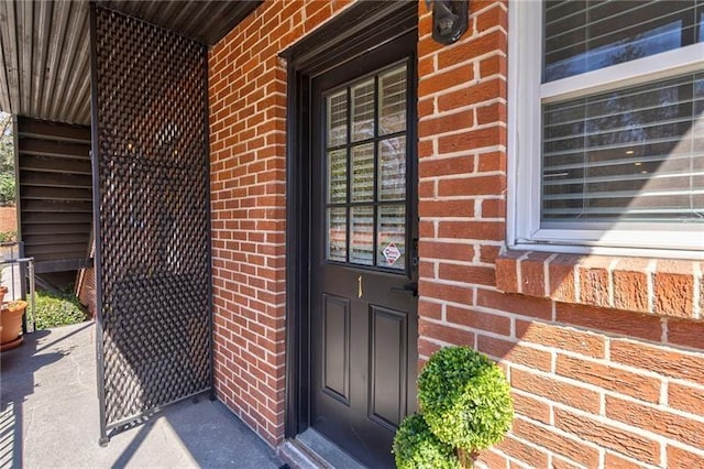 4282 Roswell Rd NE Unit G1, Atlanta, GA 30342 - doorway to property featuring brick siding and a porch