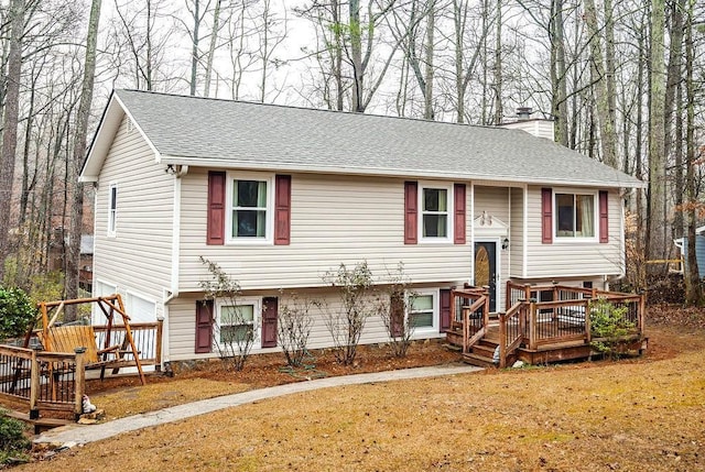 raised ranch featuring a wooden deck