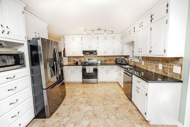 kitchen featuring white cabinetry, sink, range hood, and appliances with stainless steel finishes